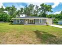 Well-kept single-story home with lush front yard and attached garage at 1133 Nw 122Nd Pl, Citra, FL 32113