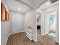 Bright foyer featuring wood-look flooring, white walls, and access to various rooms in the home at 11330 Sw 61St Cir, Ocala, FL 34476