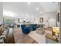 Open-concept living room featuring modern furnishings and abundant natural light with luxury vinyl plank flooring at 11330 Sw 61St Cir, Ocala, FL 34476
