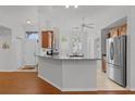Bright kitchen with a breakfast bar, modern appliances, and an adjacent dining area featuring natural light at 11598 Sw 74Th Ct, Ocala, FL 34476