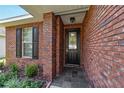 Close-up of front entrance featuring a black door and brick facade at 2127 Ne 38Th Ter, Ocala, FL 34470