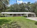 Charming single story house with brick detail, large front yard and carport at 2155 Nw 27Th Ave, Ocala, FL 34475