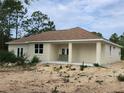 Exterior back view of home featuring covered patio at 2283 Sw 140Th Ct, Ocala, FL 34481