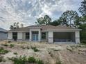 Charming home exterior featuring a two-car garage and stone accents at 2283 Sw 140Th Ct, Ocala, FL 34481