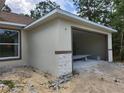 Exterior view of the home featuring a 2-car garage and stone accents at 2283 Sw 140Th Ct, Ocala, FL 34481