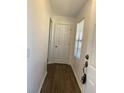 Clean entryway featuring wood-look flooring, a white door, and a window with blinds at 3381 Nw 44Th Ct, Ocala, FL 34482
