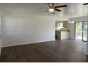 Open living room with wood-look floors and neutral tones, flowing into the adjacent kitchen at 3381 Nw 44Th Ct, Ocala, FL 34482