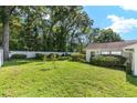 Large backyard with mature trees, privacy fence and manicured bushes at 3515 Ne 43Rd Pl, Ocala, FL 34479