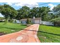 Charming single-story home with a long driveway, landscaped front yard and welcoming curb appeal at 3515 Ne 43Rd Pl, Ocala, FL 34479