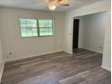 Bright living room features neutral walls, new floors, and natural light from a large window at 4701 Ne 9Th St, Ocala, FL 34470