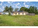Inviting single-story home with a well-manicured lawn, features solar panels, and fenced backyard for privacy at 51 Pine Trace Loop, Ocala, FL 34472