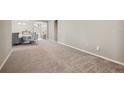 Open-concept living room featuring neutral carpet and inviting spaces at 5239 Sw 114Th Street Rd, Ocala, FL 34476