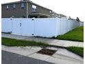 White vinyl fence enclosing the back yard is accessible through a gate at 5962 Sw 80Th Ln, Ocala, FL 34476