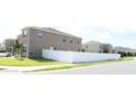 Home with a white vinyl fence enclosing the back yard located in a neighborhood at 5962 Sw 80Th Ln, Ocala, FL 34476
