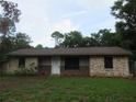 Charming single-story home with stone accents and a well-manicured lawn at 6141 Nw 64Th Ct, Ocala, FL 34482