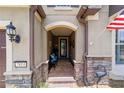 Inviting front porch with stone accents, seating, and views of the well-kept lawn at 7814 Sw 97Th Cir, Ocala, FL 34481