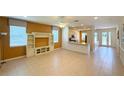 Spacious living room with tile flooring, a ceiling fan, and plenty of natural light at 8303 Sw 78Th Cir, Ocala, FL 34476