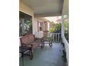 Cozy front porch showcasing a wooden bench and rocking chair for relaxing at 8450 Sw 90Th St # D, Ocala, FL 34481