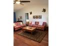 Comfortable living room with hardwood floors, traditional rug, and lots of seating at 8450 Sw 90Th St # D, Ocala, FL 34481