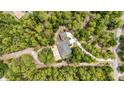 An aerial view of a beautiful home surrounded by lush trees and greenery, highlighting its secluded location at 8605 Sw 209Th Court Rd, Dunnellon, FL 34431