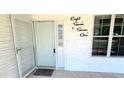 Charming front porch showcasing the home's address and entry with textured wall and window at 8771 Sw 115Th St, Ocala, FL 34481