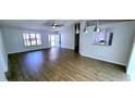 Open-concept living room featuring modern flooring, pendant lighting and access to the front door at 8771 Sw 115Th St, Ocala, FL 34481