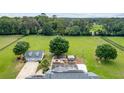 Expansive horse property showcasing a pool, large lawn, and detached garage at 9095 Sw 9Th Ter, Ocala, FL 34476