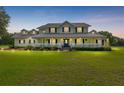 Stunning view of a two-story home with beautiful lighting at dusk at 9095 Sw 9Th Ter, Ocala, FL 34476