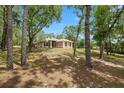 Secluded single-story home surrounded by mature trees, offering privacy and a serene setting at 9180 Sw 202Nd Avenue Rd, Dunnellon, FL 34431
