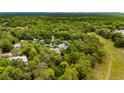 Lush aerial view of a home nestled among dense trees in a rural, wooded neighborhood at 9213 Sw 197Th Cir, Dunnellon, FL 34432