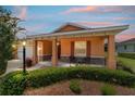Inviting front porch with stone accents and colorful plants at 9236 Sw 91St Court Rd, Ocala, FL 34481