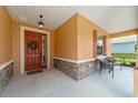 Inviting front porch with stone accents, a wreath-adorned door, and cozy seating at 9236 Sw 91St Court Rd, Ocala, FL 34481