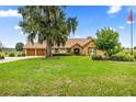 Charming home with stone facade, neutral stucco, manicured lawn, and mature landscaping at 12131 Ne 10Th Ter, Ocala, FL 34479