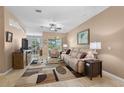 Cozy living room featuring a neutral color palette, comfortable seating, and a view to the lanai at 15549 Sw 11Th Terrace Rd, Ocala, FL 34473
