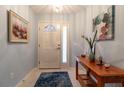 Bright foyer features tile flooring, a console table, and decorative artwork at 1768 Sw 156Th Ln, Ocala, FL 34473