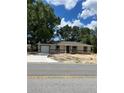 Inviting single-story home featuring an attached garage and cozy entrance at 19622 Sw Marine Blvd, Dunnellon, FL 34431