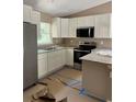Modern kitchen features stainless steel appliances, white cabinetry, and granite countertops at 19622 Sw Marine Blvd, Dunnellon, FL 34431
