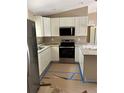 Well-lit kitchen features stainless appliances, granite countertops, and ample cabinetry at 19622 Sw Marine Blvd, Dunnellon, FL 34431