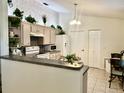 Cozy kitchen featuring neutral cabinets, modern appliances, and eat-in bar at 2305 Ne 40Th Ave, Ocala, FL 34470