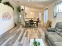 Open-concept living space with dining area, wood-look flooring, and natural light at 2305 Ne 40Th Ave, Ocala, FL 34470