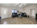 Bright living room featuring wood-look tile floors, two sofas, and a glass coffee table at 28 Hemlock Radial Loop, Ocala, FL 34472