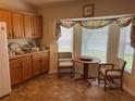 Cozy kitchen nook featuring a round table with seating, under a bright window with decorative curtains at 4622 Ne 15Th St, Ocala, FL 34470