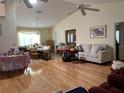 Open-concept living room with hardwood floors, ceiling fans, and a blend of traditional and modern decor at 4622 Ne 15Th St, Ocala, FL 34470