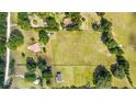 Expansive aerial shot showcases multiple homes, vast green spaces, and serene surroundings at 475 Ne 155Th Pl, Citra, FL 32113
