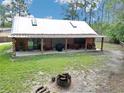 Spacious backyard with covered patio offers a serene retreat, perfect for relaxation and outdoor entertaining at 5630 Se 183Rd Avenue Rd, Ocklawaha, FL 32179