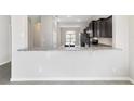 Kitchen bar features a view into the dining room with stylish gray and white countertops at 6299 Sw 90Th St, Ocala, FL 34476