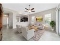 Bright living room featuring neutral decor, tile floors, and plenty of natural light at 6299 Sw 90Th St, Ocala, FL 34476