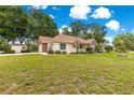 Charming single-story home with a well-manicured lawn and quaint curb appeal at 6551 Se 11Th Loop, Ocala, FL 34472