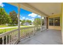 Inviting covered front porch with white railing and ample space for seating at 6551 Se 11Th Loop, Ocala, FL 34472