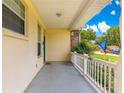 Comfortable front porch with a blue door, offering a relaxing outdoor space at 6551 Se 11Th Loop, Ocala, FL 34472